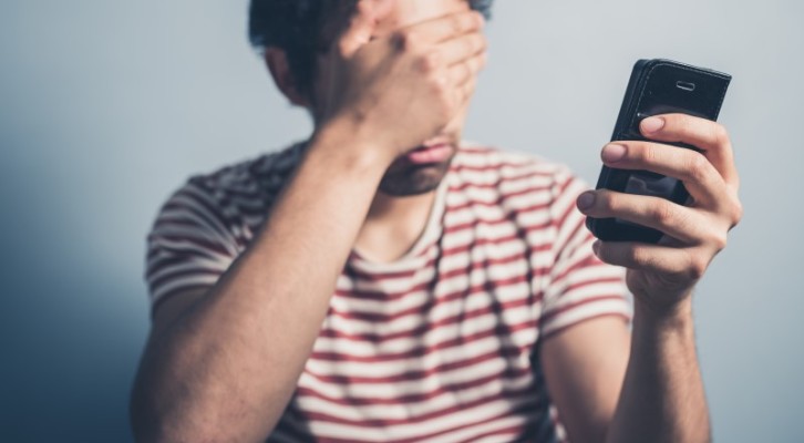 man closed his eyes unable to see mobile screen